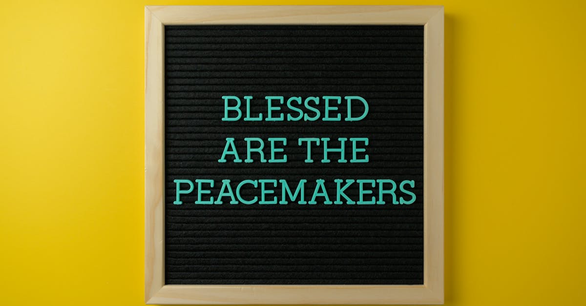 Letter board with 'Blessed are the Peacemakers' against a vibrant yellow background.