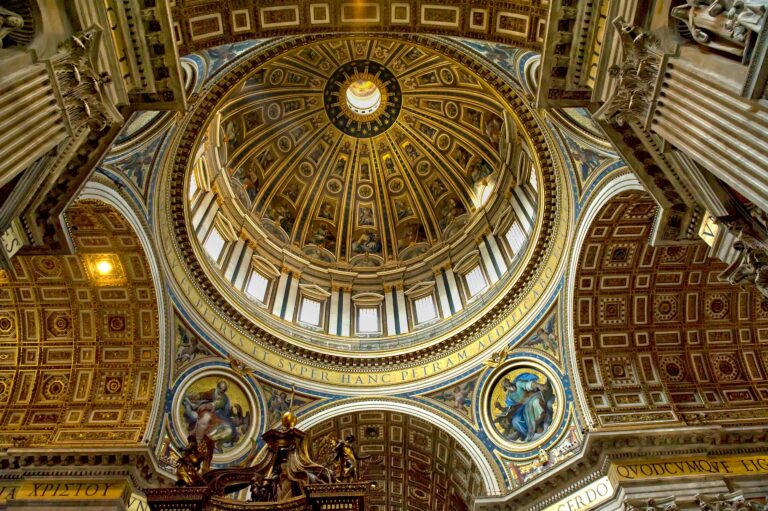 Stunning view of St. Peter's Basilica dome showcasing intricate architectural and religious art details.